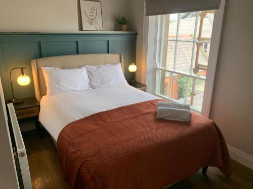 a bed in a room with a large window at The Auction House in Belfast