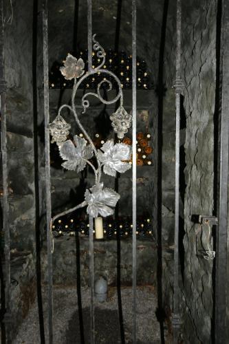 a metal flower chandelier on a door with lights at Apartment Vínny Dom in Viničky