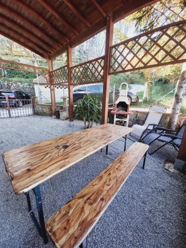 a wooden bench sitting under a gazebo at Villino I Girasoli in Chianni
