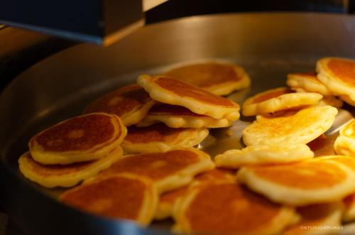 a bunch of pancakes are cooking in a pan at IntercityHotel Graz in Graz