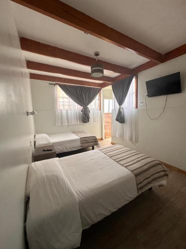 Llit o llits en una habitació de Hostal Casa Norte