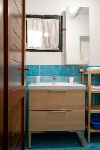 a bathroom with a sink and a window at Caletta Nest 108 in Porto Rotondo