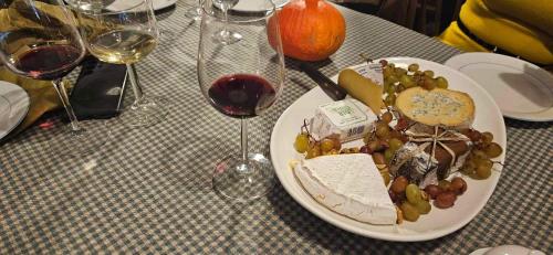 a plate of food on a table with wine glasses at Sambre d'amis in Landelies