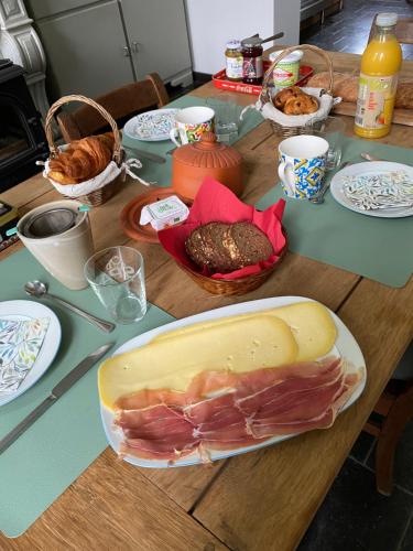 a table with a cutting board with food on it at Sambre d'amis in Landelies