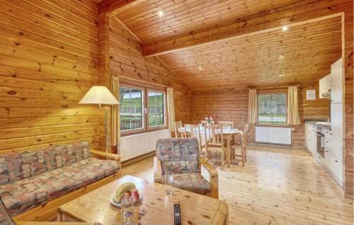 a living room with a couch and a table in a cabin at 3 Bedroom Amazing Home In Masserberg in Masserberg