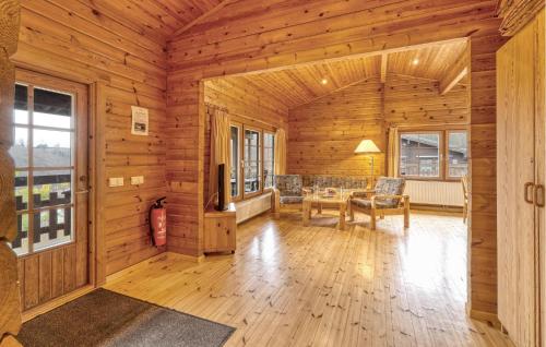 a living room with wooden walls and a wooden floor at Gorgeous Home In Masserberg in Masserberg