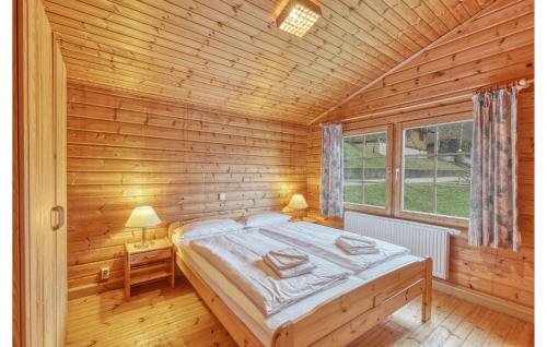 a bedroom with a bed in a wooden room at Gorgeous Home In Masserberg in Masserberg