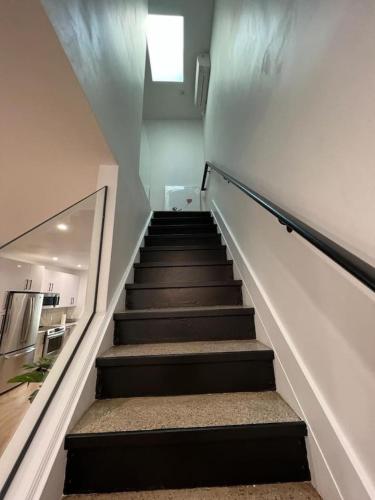a staircase leading up to a room with a kitchen at Stunning Family Style Duplex in New York