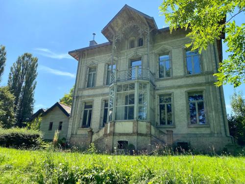 an old house on a hill with green grass at Sambre d'amis in Landelies