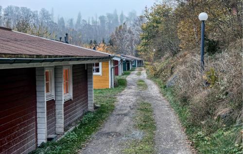 a dirt road next to a row of houses at 2 Bedroom Nice Home In Masserberg in Masserberg