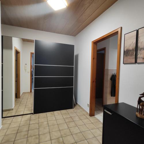a room with a closet with a black door at Kero - Ferienwohnung in Rauenberg