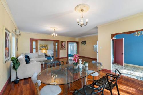 a living room with a glass table and chairs at Spacious Affordable 7B3B 2 Living Pool Yard and Mall in Brisbane