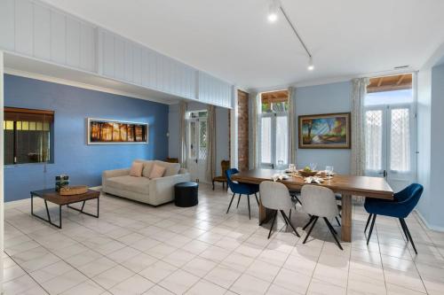 a living room with a table and a couch at Spacious Affordable 7B3B 2 Living Pool Yard and Mall in Brisbane