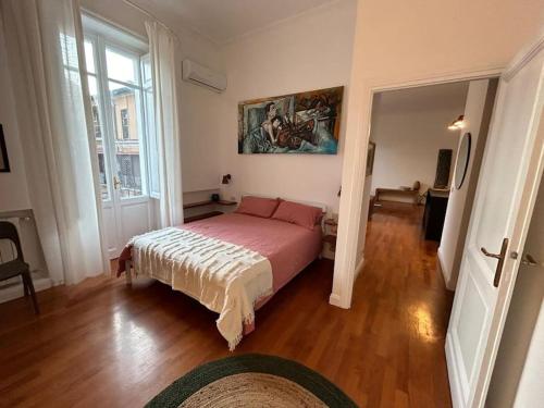 a bedroom with a bed and a painting on the wall at Your nest at Colosseum!! in Rome