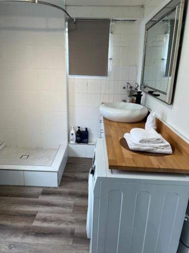 a white bathroom with a sink and a tub at Cozy 2Beds Studio witch Kitchen Laundry near Zoo and Mall in Jindalee
