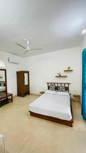 a bedroom with a large bed in a room at Jaladarshini Lakeside Gardens in Kollam