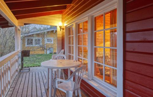 a wooden porch with a table and chairs on it at Cozy Home In Masserberg With Wifi in Masserberg