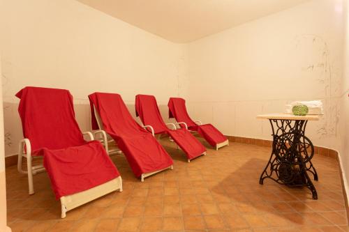 a row of red chairs in a waiting room at Residence Alesi in Malcesine