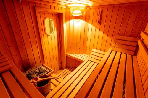 a wooden sauna with two benches and a light at Residence Alesi in Malcesine