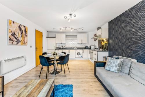 a living room with a couch and a table at 30 percent off! Stylish 2 Bed 2 Bath Abode with Parking in Dewsbury