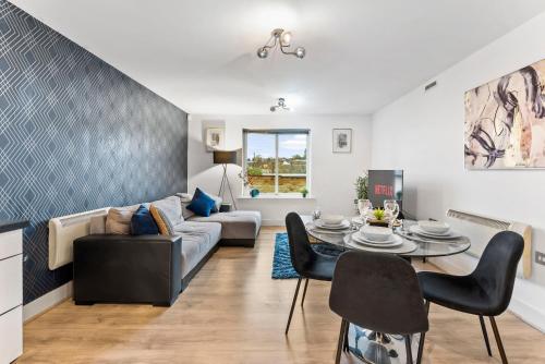 a living room with a couch and a table at 30 percent off! Stylish 2 Bed 2 Bath Abode with Parking in Dewsbury