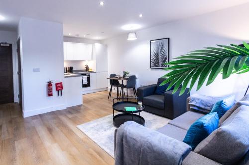a living room with a couch and a table at Trendy Apt in the Heart of MCR in Manchester