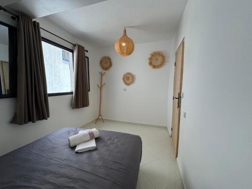 a bedroom with a bed with two towels on it at L'étoile de taghazout in Taghazout
