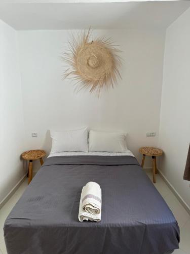 a bedroom with a bed with a towel on it at L'étoile de taghazout in Taghazout