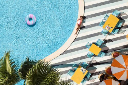 una vista panoramica su una piscina con ombrelloni e piscina di tent Mojito Suites a Magaluf
