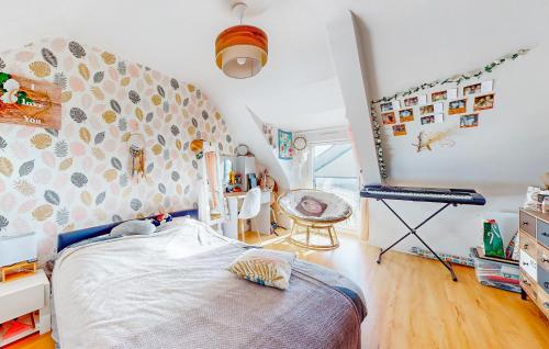 a bedroom with a bed and a desk in a room at Gorgeous Home In Quessoy in Quessoy