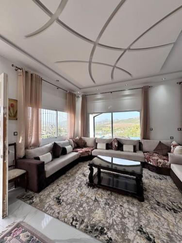 a large living room with a couch and a table at Villa de Vacances avec Piscine in Tangier