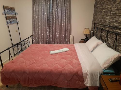 a bedroom with a bed with a red comforter at Villa of byron in Kastrákion