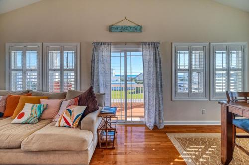 a living room with a couch and large windows at North Topsail Beach Rental- Water Views - Elevator - Dogs Allowed w added fee in North Topsail Beach