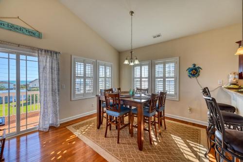 a dining room with a table and chairs at North Topsail Beach Rental- Water Views - Elevator - Dogs Allowed w added fee in North Topsail Beach