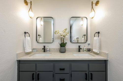 a bathroom with two sinks and two mirrors at Point Lyle in Mosier