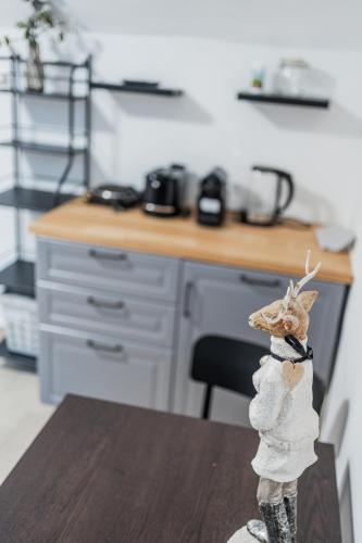 a figurine of a reindeer standing on a table in a kitchen at Innsbruck Underground Atelier in Innsbruck