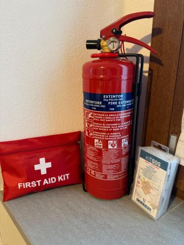 a red fire hydrant sitting next to a box at Casa Margherita in San Pellegrino Terme