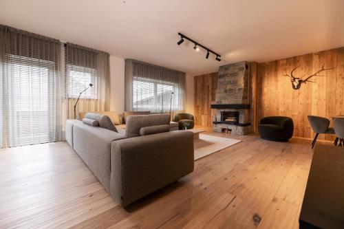 a living room with a couch and a fireplace at Villa Berwang in Berwang