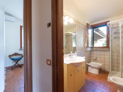 a bathroom with a sink and a toilet and a mirror at Holiday Home Rosa by Interhome in Pian dʼAlma
