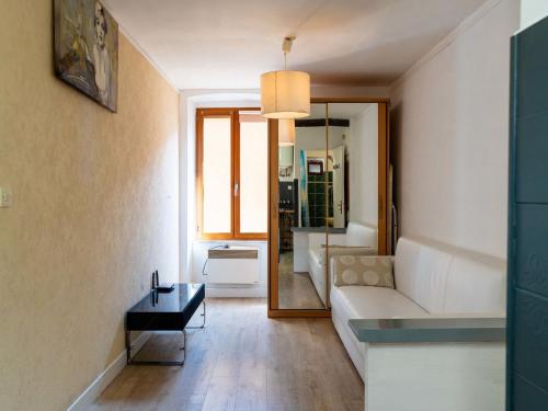 a living room with a white couch and a table at Apartment The Nest by Interhome in Ventimiglia