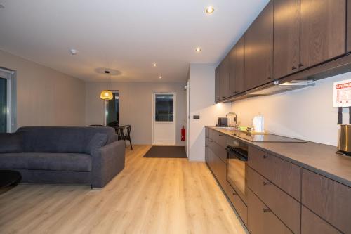 a kitchen and a living room with a couch at Storigardur Premium Apartments in Húsavík