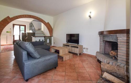 a living room with a couch and a fireplace at Cozy Home In Fauglia With Wifi in Fauglia