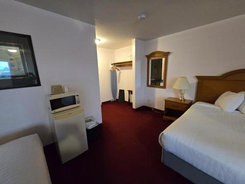 a hotel room with two beds and a television at Travelodge by Wyndham Port Elgin in Port Elgin