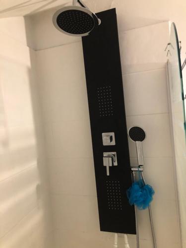 a shower with a black control panel on the wall at Appart Hotel Le Victor Hugo Art Mechanical et sa pizza offerte in Aurillac