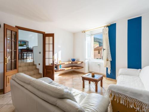 a living room with a couch and a table at Holiday Home In te l'Aia by Interhome in Taggia
