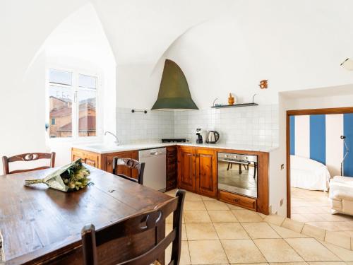 a kitchen with a wooden table in a room at Holiday Home In te l'Aia by Interhome in Taggia