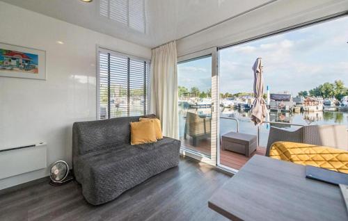 a living room with a couch and a large window at House Boat Statia in Maastricht