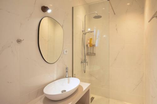 un bagno bianco con lavandino e doccia di Villa Antreas Mentoros a Karavádhos