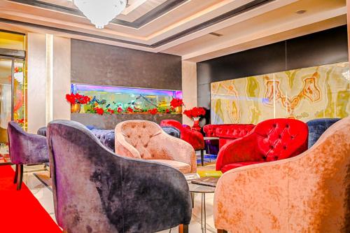 a room with chairs and a table and a painting at Hotel Vivas in Durrës