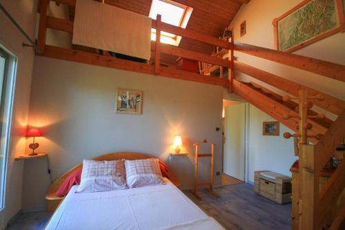 a bedroom with a bed and a loft at L'ermitage in Chambéry